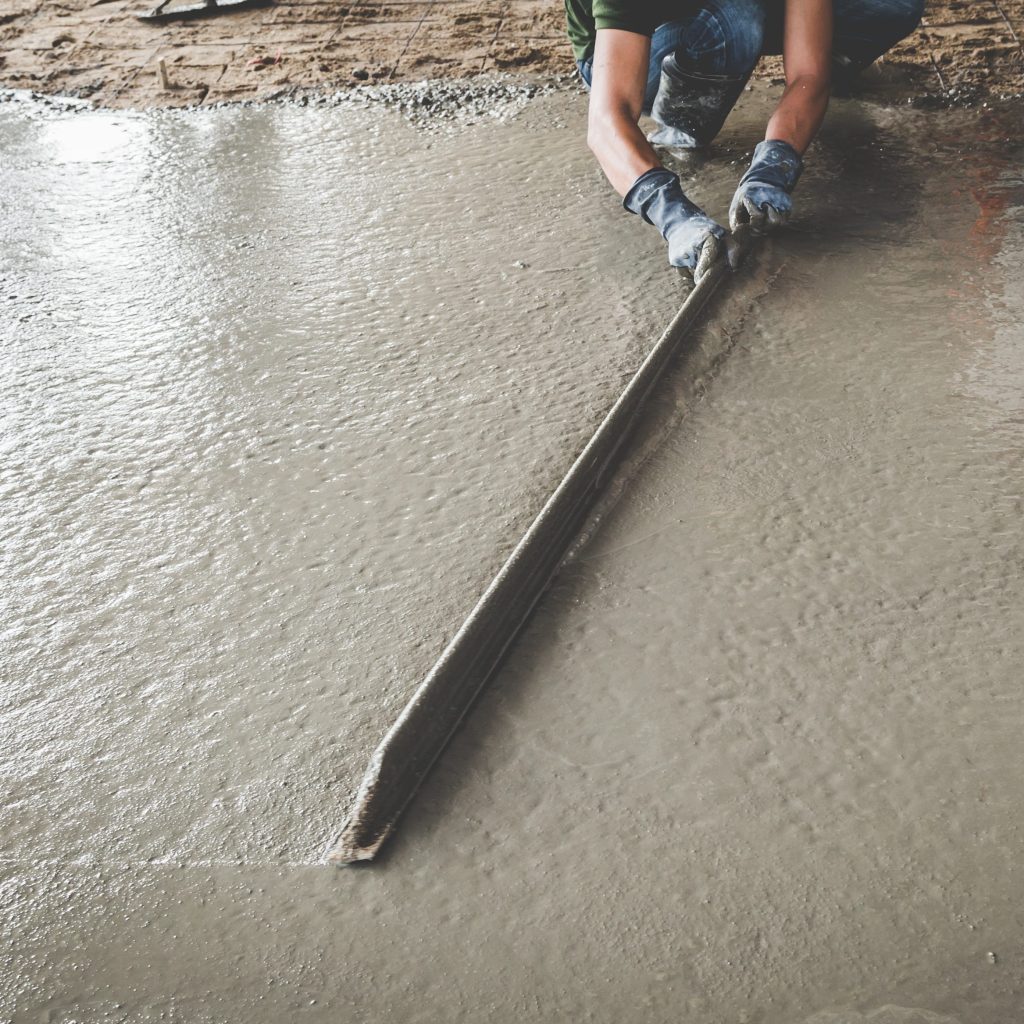 Professional floor screeding by Renov8 Plastering Services North Devon, ensuring a smooth and level surface.